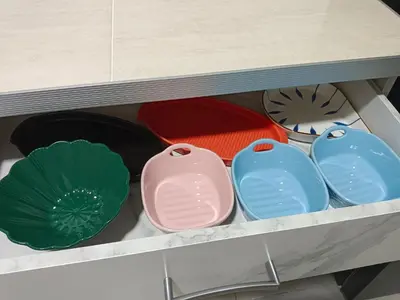 a drawer filled with different colored plates and bowls at Happy Homestay TheVenus Sitiawan in Sitiawan