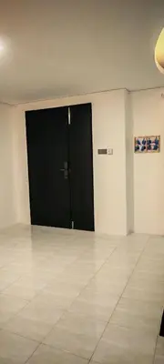 a black door in a room with a tile floor at 23 Inn Singlebed Share Bathroom No Window in Bukit Mertajam