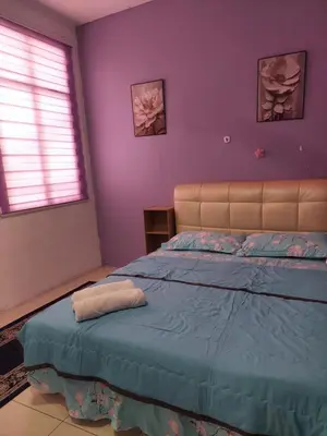 a bedroom with a bed with purple walls at Jerai Geopark Cottage Alamanda in Baling