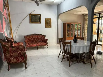 a living room with a table and chairs at HOMESTAY Sg Petani in Sungai Petani