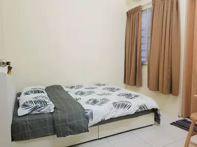 a bed sitting in a room with a window at Lovely Homestay in Gerik with Free Netflix & WiFi in Gerik