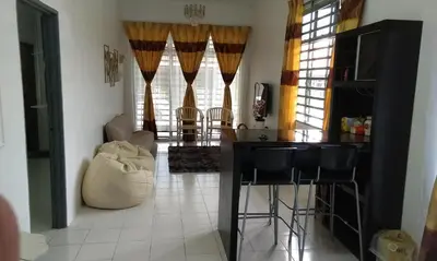 a living room with a bar and a table and chairs at AL DHAKIYA HOMESTAY KULIM 3r2b in Kulim