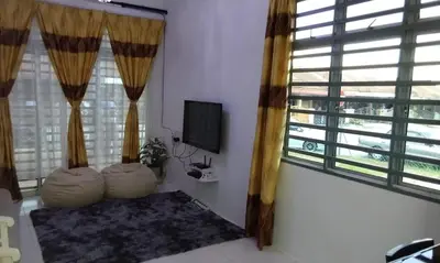 a living room with a tv and a large window at AL DHAKIYA HOMESTAY KULIM 3r2b in Kulim