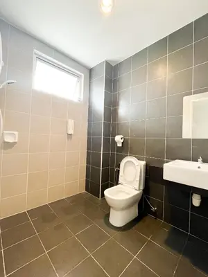 a bathroom with a toilet and a sink at Comfy Cafe 43 Homestay- Holiday Home in Tanah Rata