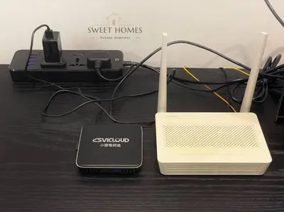 a nintendo wii game system with a charger and a router at Urban Modern3BR CityView 7pax Infinity Pool in George Town