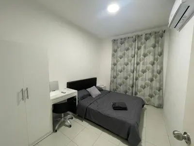 a small bedroom with a bed and a desk at The Anderson Ipoh in Ipoh