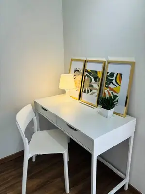 a white desk with a chair and three pictures at The Cove Hillside Ipoh by Iconique in Tambun