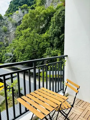 a wooden bench sitting on top of a balcony at The Cove Hillside Ipoh by Iconique in Tambun