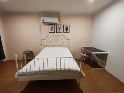a bedroom with a white bed and a desk at Songtam Hotel in Ipoh
