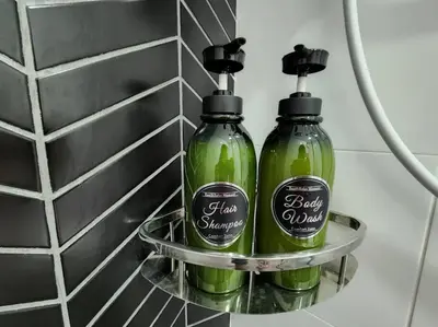 two green bottles sitting on a shelf in a bathroom at IPOH City Horizon08 - 8 mins to Concubine Lane and Old Town Ipoh, 3 mins Walking to Food Places & Convenient Store by Happy Homestay in Ipoh
