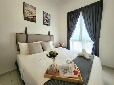 a bed with a tray of flowers and a window at IPOH City Horizon08 - 8 mins to Concubine Lane and Old Town Ipoh, 3 mins Walking to Food Places & Convenient Store by Happy Homestay in Ipoh