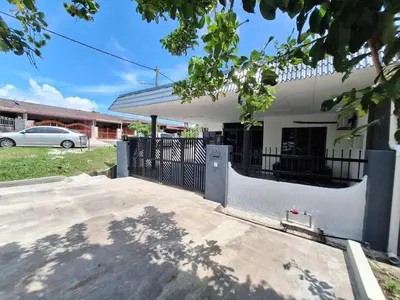 a white house with a gate in front of it at Mukhriz 2 Homestay in Kulim