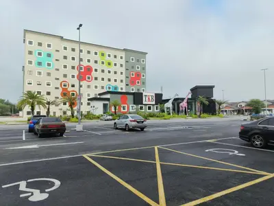 a parking lot with cars parked in front of a building at Soho LESTARI in Seri Iskandar