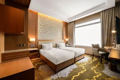 a hotel room with a bed and a desk at St Giles Wembley Penang in George Town