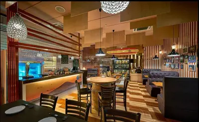 a restaurant with a bar and tables and chairs at Cititel Express Penang in George Town