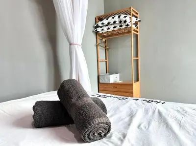 a rolled up towel on a bed with a mirror at Unicorn Fairy Theme 2BR Airport Suite# Straits Intl# Pantai Hospt in Bayan Lepas