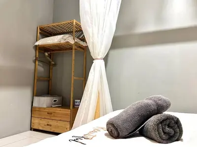 a bedroom with a bed with a book shelf and towels at Unicorn Fairy Theme 2BR Airport Suite# Straits Intl# Pantai Hospt in Bayan Lepas