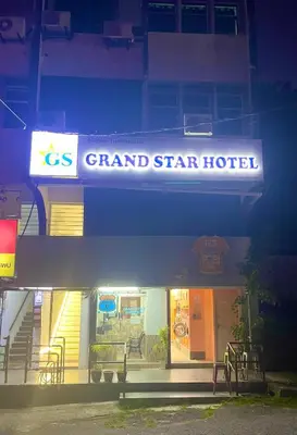 a grand star hotel sign in front of a building at Grand Star Hotel in Batu Ferringhi