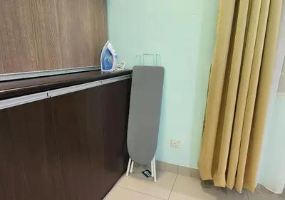 a room with a desk with a chair and a curtain at Homestay Pulau Pinang Urban Sky Guesthouse in Bayan Lepas