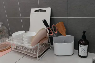 a kitchen counter with a basket of dishes and a bottle of wine at Taiping Homestay 5R3B, 9mins - Zoo & Lake Garden Taiping in Taiping