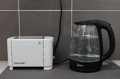 a black and white blender next to a toaster at Taiping Homestay 5R3B, 9mins - Zoo & Lake Garden Taiping in Taiping