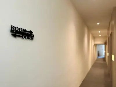 a hallway with a room doom sign on the wall at Milan Backpacker Hostel in George Town