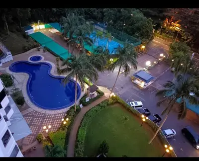an aerial view of a swimming pool at night at Seri Sayang 2 Bedrooms Seaview Resort in Batu Ferringhi