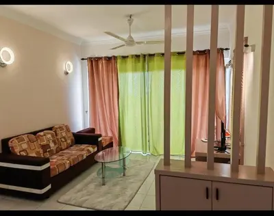 a living room with a couch and a table at Seri Sayang 2 Bedrooms Seaview Resort in Batu Ferringhi