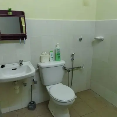 a bathroom with a toilet and a sink at Lily Impiana Homestay in Baling