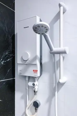 a white soap dispenser on a bathroom wall at Beacon Suites #Georgetown #Rooftop Pool #20 #Cozy in George Town