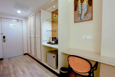 a small kitchen with a desk and a chair in a room at The Host Hotel in Ipoh
