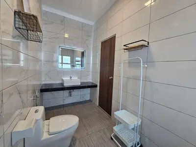 a white bathroom with a toilet and a sink at jia Residence 21 pax Karaoke & Snooker in Ipoh