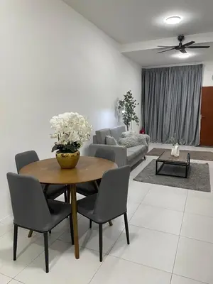 a living room with a wooden table and chairs at The Imans Place in Kepala Batas