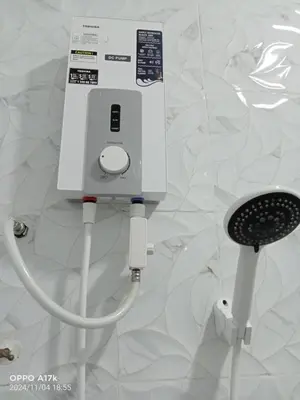 a white electrical device is plugged into a wall at Bilik Umairah in Gerik