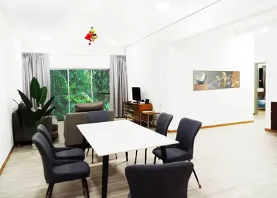 a living room with a white table and chairs at Quintet Cottage in Cameron Highlands