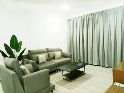 a living room with a couch and a coffee table at Quintet Cottage in Cameron Highlands