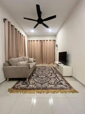 a living room with a couch and a ceiling fan at Homestay Taman Banjar Indah, Teluk Intan in Teluk Intan