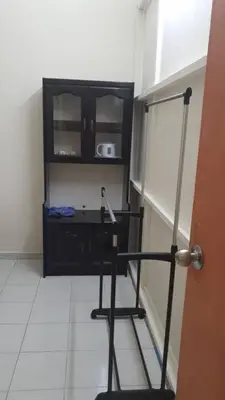 a black chair in a room with a cabinet at Taman Medan Seri Sentosa, Ayer Tawar in Ayer Tawar