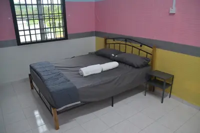 a bed with two pillows on it in a room at Yim's Homestay in Kuala Kubu Baharu