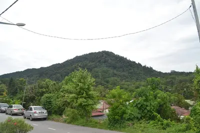 a mountain with cars parked on the side of a road at Yim's Homestay in Kuala Kubu Baharu