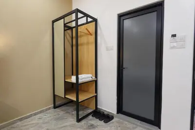 a mirror in a room next to a door at Merits Hotel Cameron Highlands in Cameron Highlands