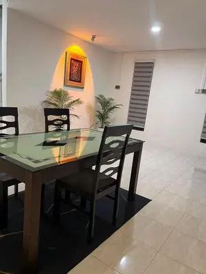 a dining room with a glass table and chairs at 23 Inn Queenbed Standard Room in Bukit Mertajam