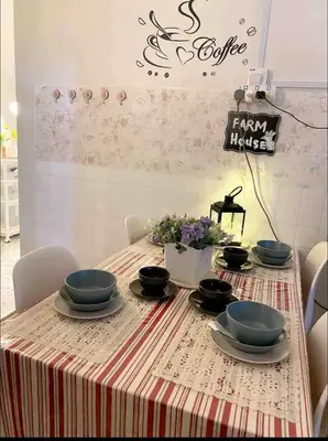 a table with blue bowls and plates on it at Cottage Near Lake Garden in Taiping
