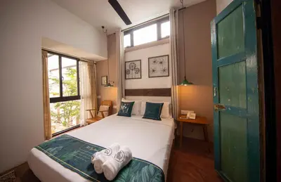 a bedroom with a bed with towels on it at Sweet Cili Boutique Hotel in George Town