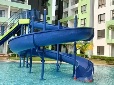 a blue slide in the water in a pool at Premium Manhattan Ipoh \u6021\u4fdd\u6c11\u5bbf, 4bedroom 12pax, water park in Ipoh
