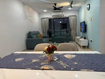 a living room with a table with a vase of flowers on it at Premium Manhattan Ipoh \u6021\u4fdd\u6c11\u5bbf, 4bedroom 12pax, water park in Ipoh
