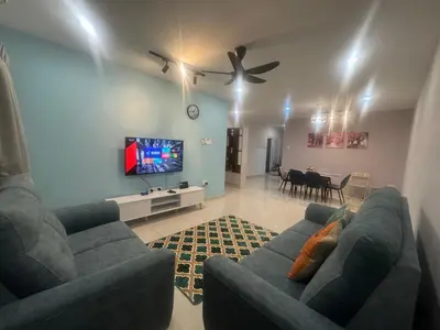 a living room with two blue couches and a tv at Premium Manhattan Ipoh \u6021\u4fdd\u6c11\u5bbf, 4bedroom 12pax, water park in Ipoh