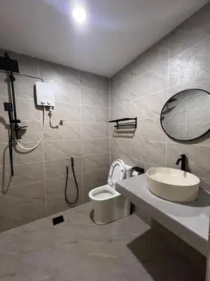 a bathroom with a sink and a toilet and a mirror at Kangsar KK Hotel in Kuala Kangsar