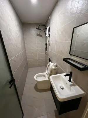 a bathroom with a toilet and a sink at Kangsar KK Hotel in Kuala Kangsar