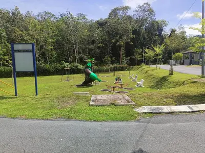 a park with a playground with a slide and birds at Rumah SK in Batu Kurau
